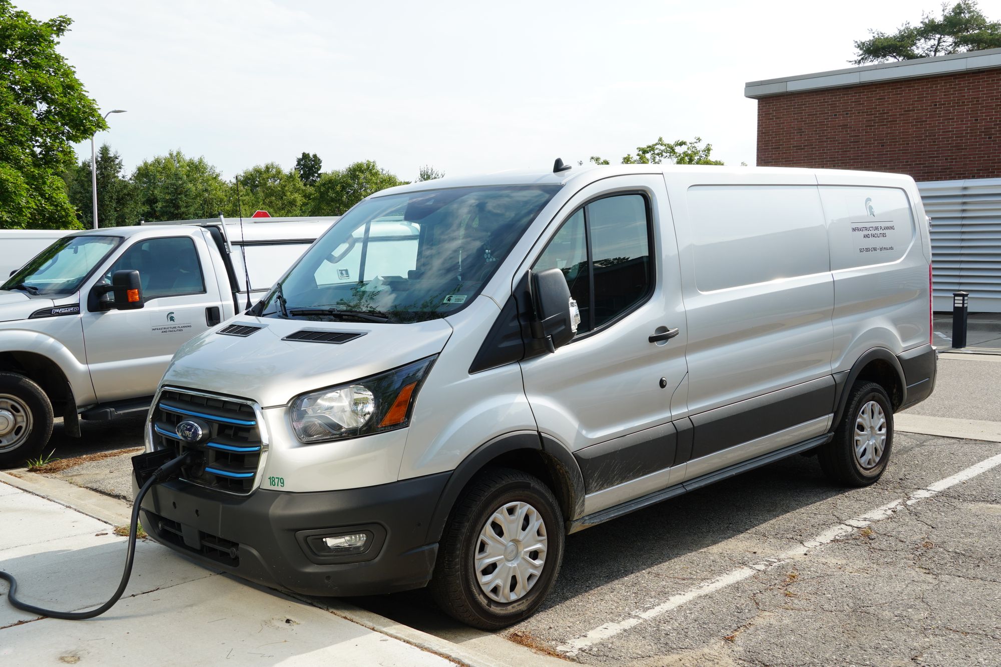 a Ford E-Transit plugged in at a charging station
