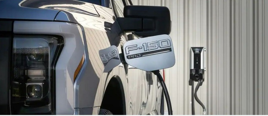 2023 Ford F one Fifty Lightning Pros on a job site charging.
