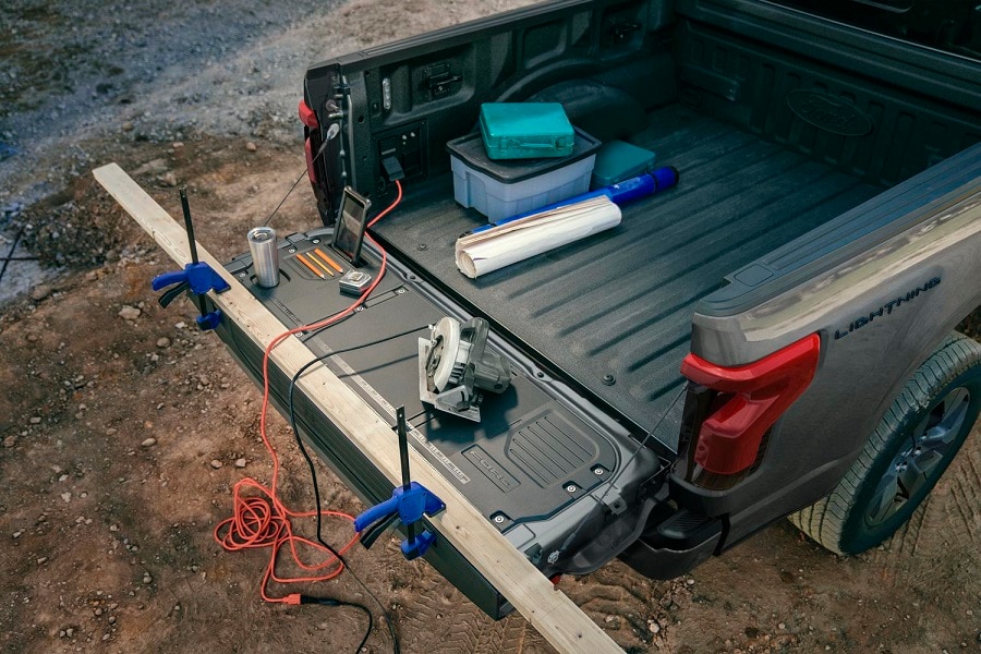 Shot of the tailgate work surface on a F-150 Lightning Pro with tools and materials on it