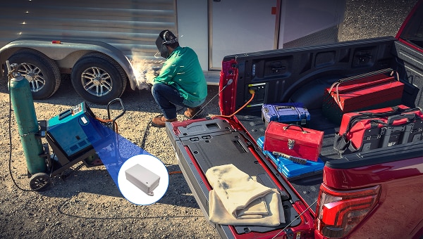 Ford truck bed full of trackable assets on a work site.