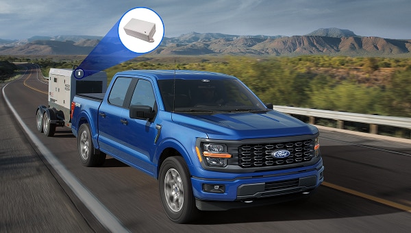 Image of a Ford F-150 towing a small generator on a highway.