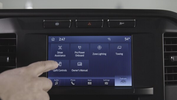 Driver using Ford Pro vehicle integration system 2.0 for upfitter controls.