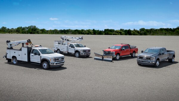 Several Ford upfitter vehicles in a parking lot.