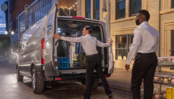 A man opening the back of a van.