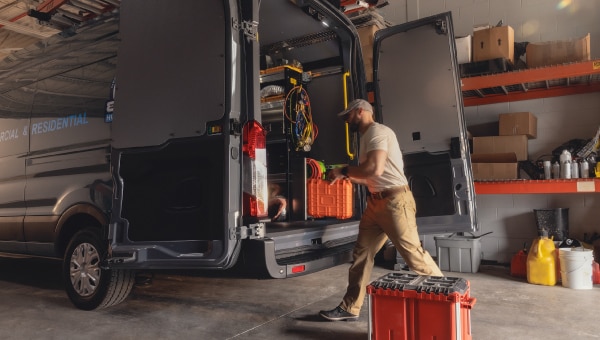 A man loading boxes into a van.