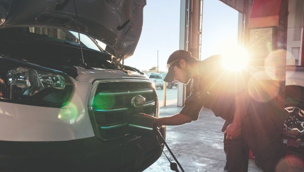 A man charging an EV.