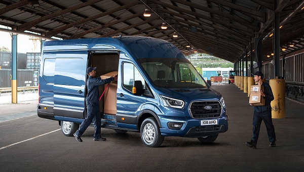 Ford Transit van conversion with delivery driver unloading packages