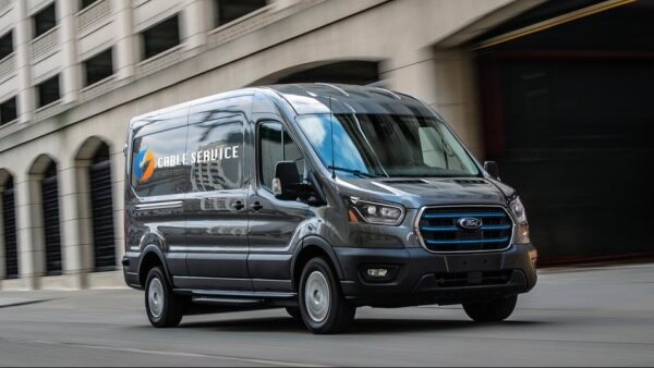 An E-Transit conversion van is on a city street.