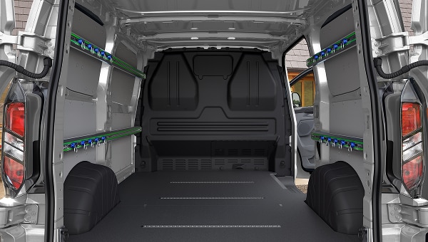 Amplio espacio de carga vacío de Ford Transit Custom 2026, destacando estanterías modulares y piso resistente.
