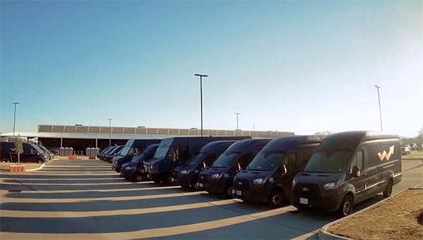 Parking lot full of company branded black color electric fleet vehicles