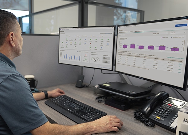 Man viewing Ford Pro Telematics software screen in an office.