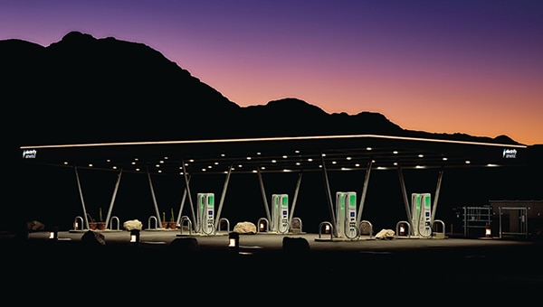 View of a Blue Oval Charge Network public charging station at twilight.