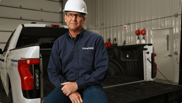 A man sitting in the bed of a Ford truck.