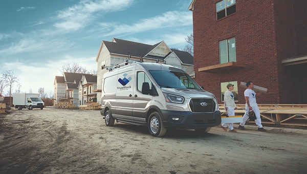 2026 Ford Transit commercial van parked at residential construction site.