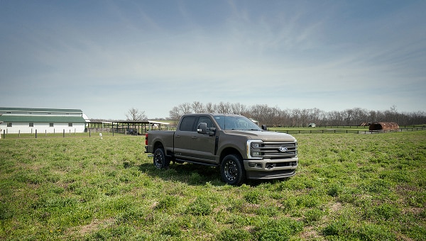 2027 Ford Super Duty truck in a field highlighting the Carhartt Package in Ford Pro news feature.