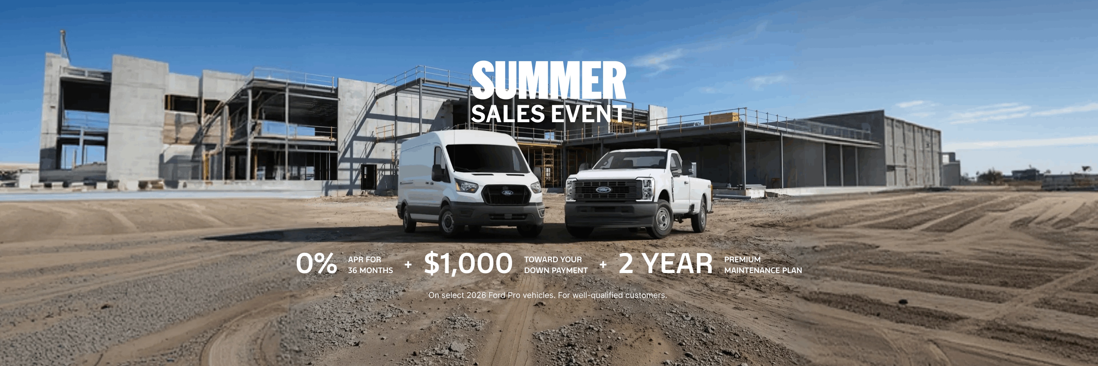 White Ford E-Transit van and Ford F-150 pickup truck parked at a construction site with buildingin the background.