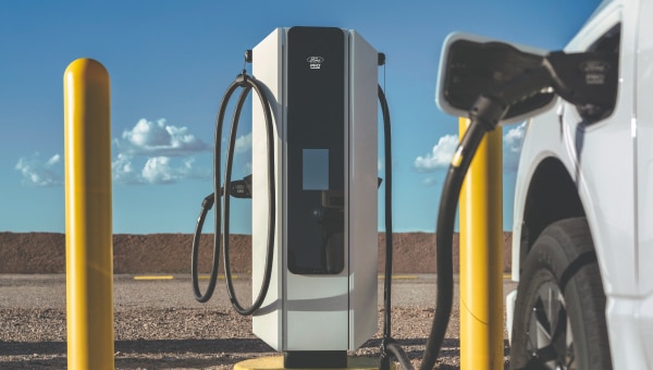 Ford electric vehicle charger with a vehicle plugged in.