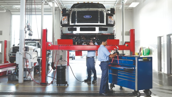 Ford truck lifted in a Commercial Vehicle Center,commercial fleet servicing.