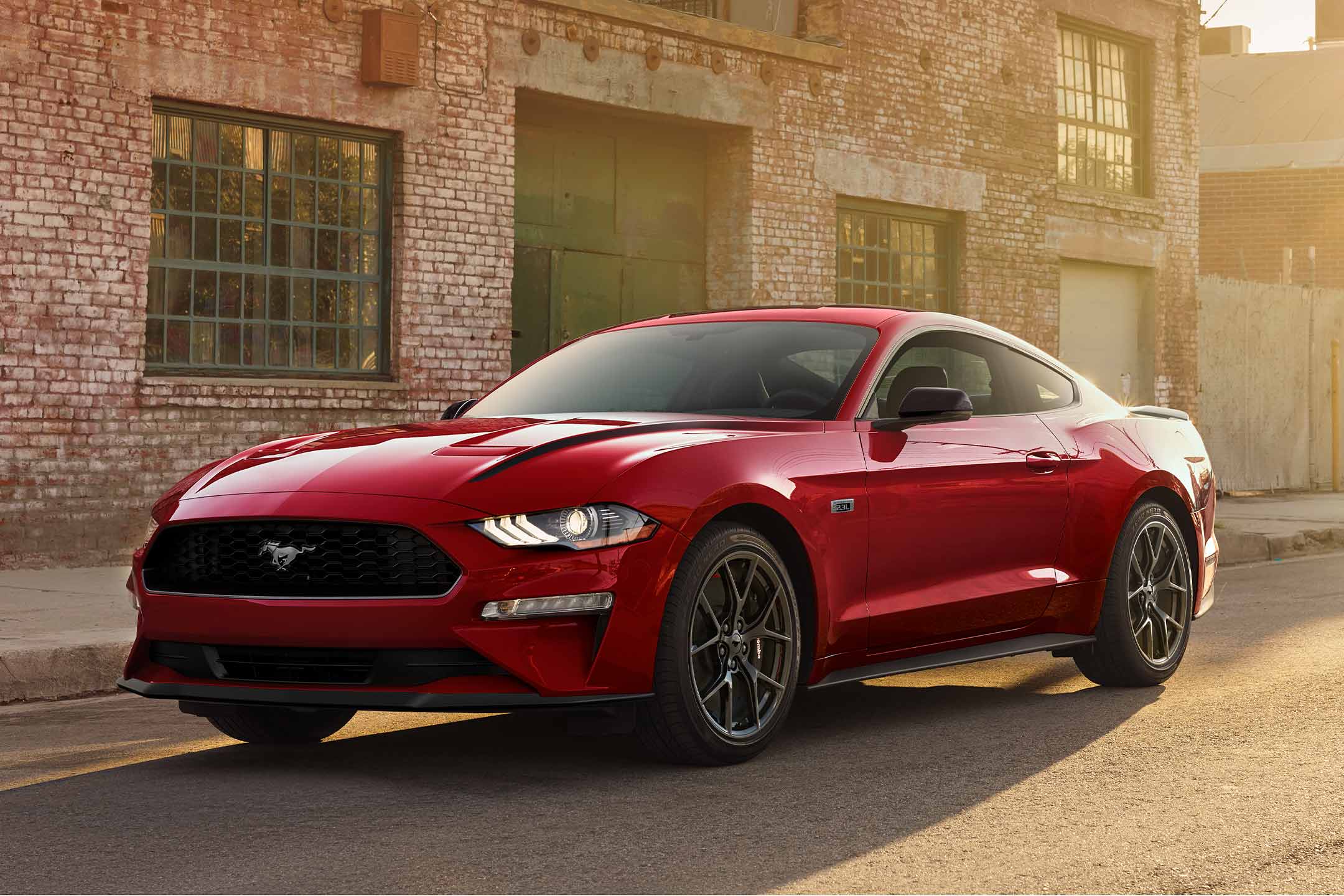 2023 Ford Mustang® 2.3L EcoBoost® parked on a street in Race Red