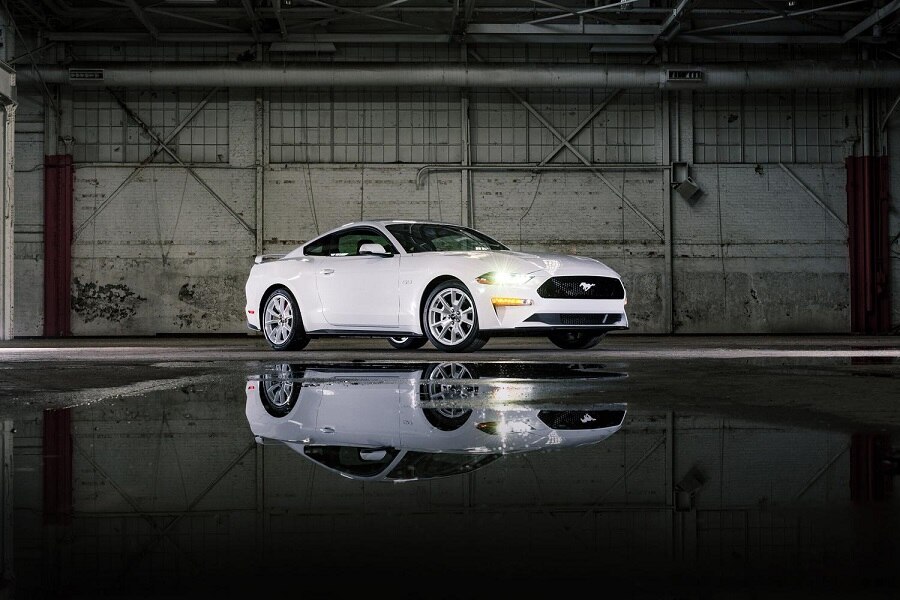 A 2023 Ford Mustang® coupe with the Mustang Ice White Appearance Package parked in a warehouse