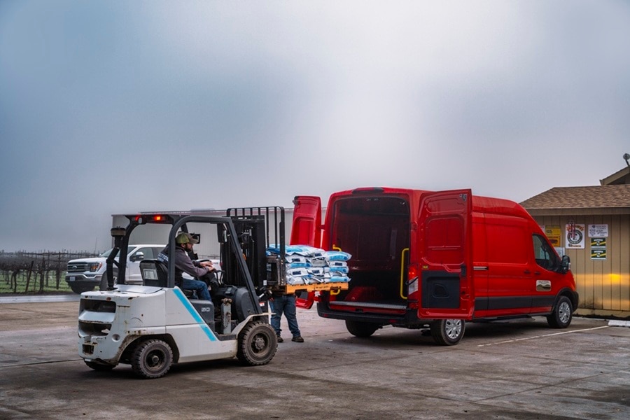 Ford E-Transit commercial van being loaded