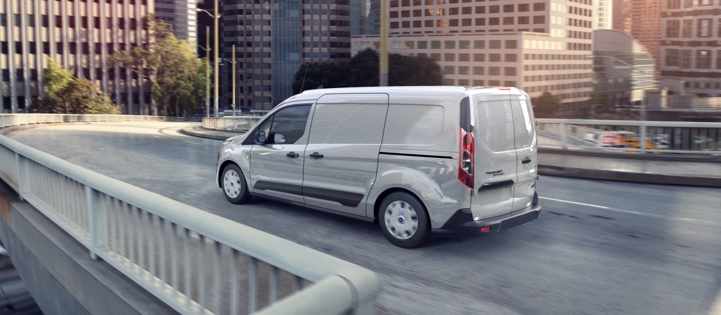 2023 Ford Transit Connect Cargo Van in Silver being driven on an expressway ramp