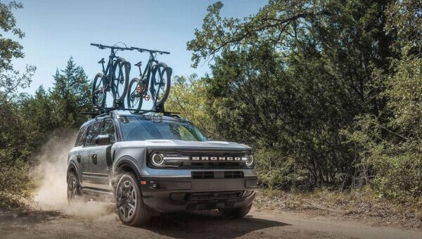 2024 Ford Bronco® Sport being driven on dirt trail with bikes on the roof