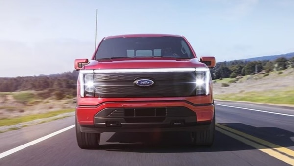 Front shot of an F-150 Lightning driving on a road
