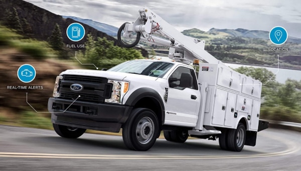 Ford Pro connected uptime system truck driving on highway.