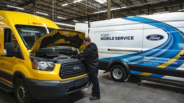 DHL fleet van receiving Ford Pro Mobile Service maintenance.