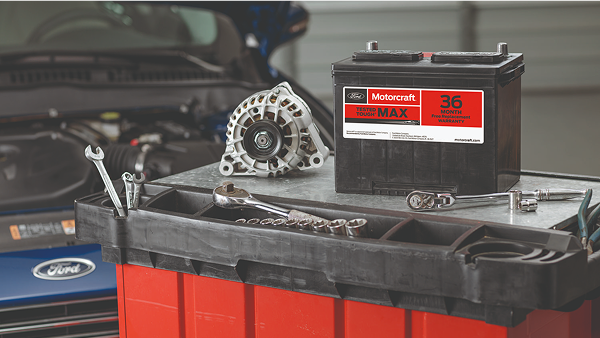 Toolbox with Ford Motorcraft battery and parts inside service bay.