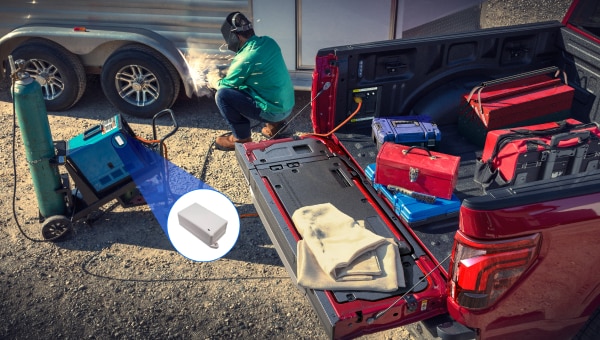 Ford truck bed full of trackable assets on a work site.