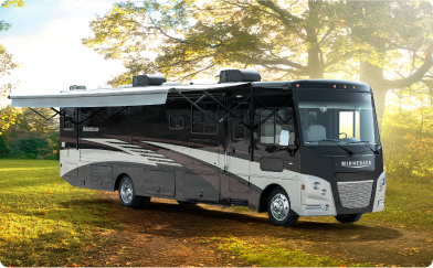 A recreational camper pared in a forest clearing.