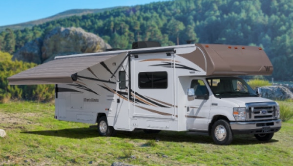 Brown recreational vehicle at a camp site.