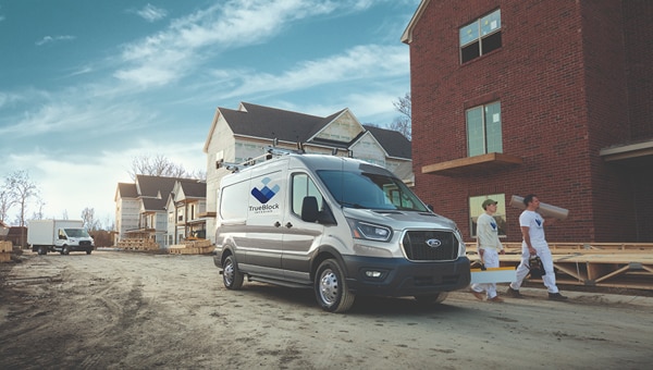 A 2026 Transit van parked alongside a neighborhood construction site.