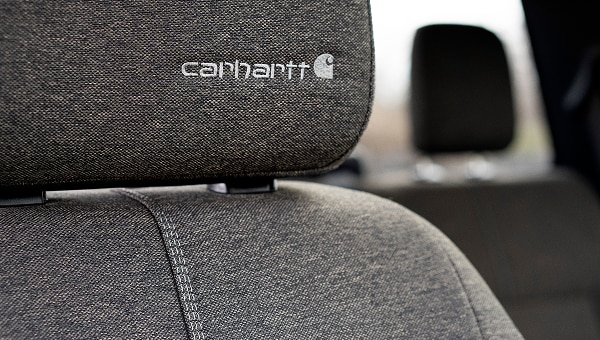 Detailed shot of the Carhartt logo embroidered on the seat headrest.